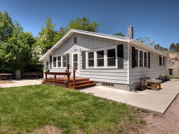 Front of duplex, door is on the left side by the patio