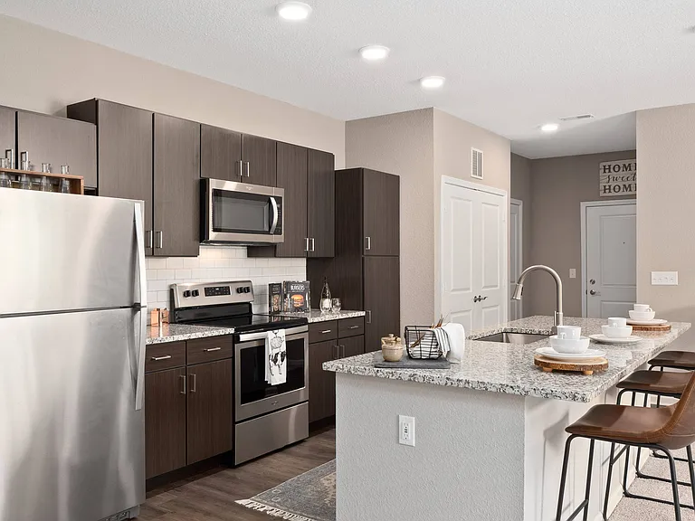 Kitchen with stainless steel appliance and island
