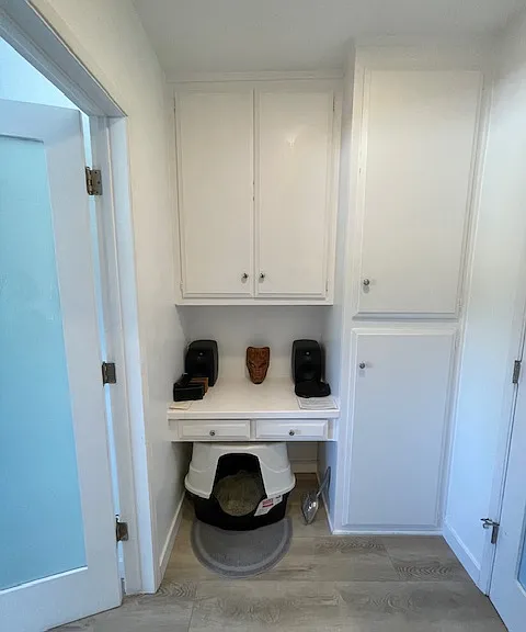 Lining closets in hallway with built in desk