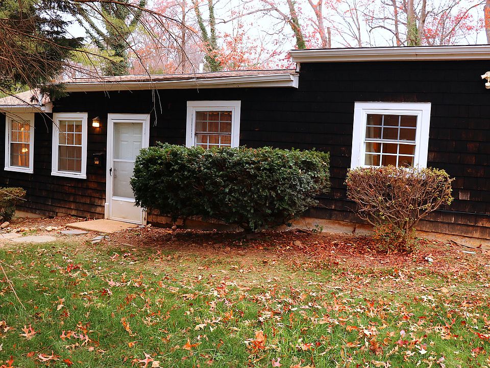 Cottage with parking spaces down flagstones to left. 2 windows to right of entry are Study/bedroom then large MB