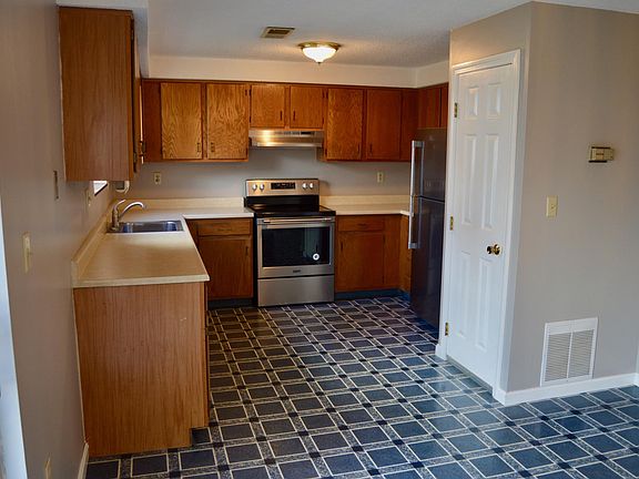 Large kitchen with SS appliances. Dishwasher, stove, and refrigerator