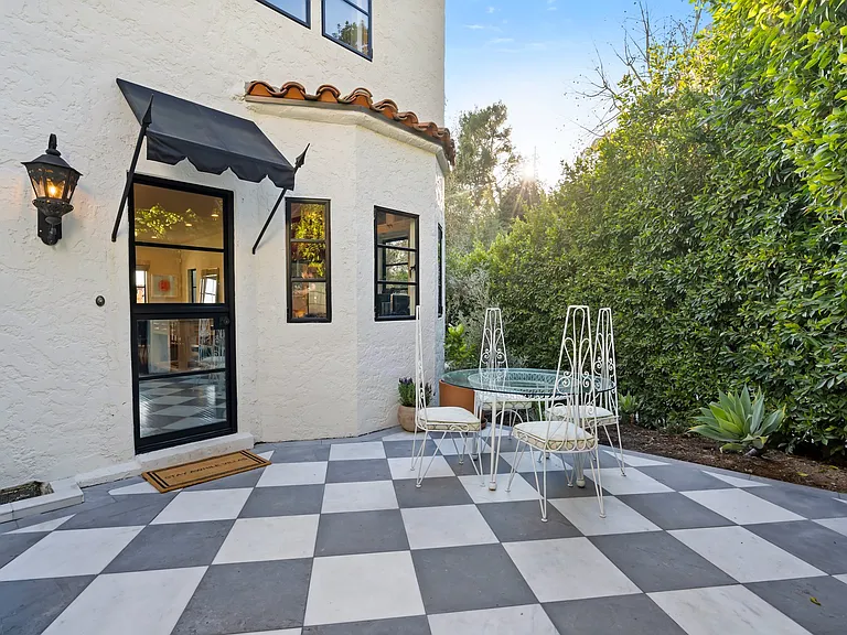 A sunlit courtyard where classic design meets effortless charm.