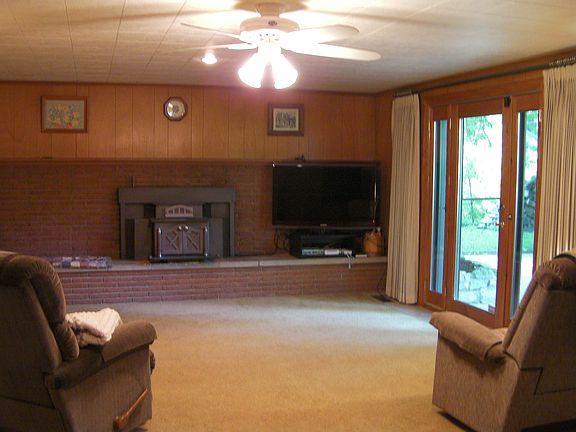 Family Room 24x15 fireplace is wood burning stove. Walk out to patio with view