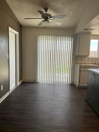 Dining area with ceiling fan; door to attached oversized 1-car garage