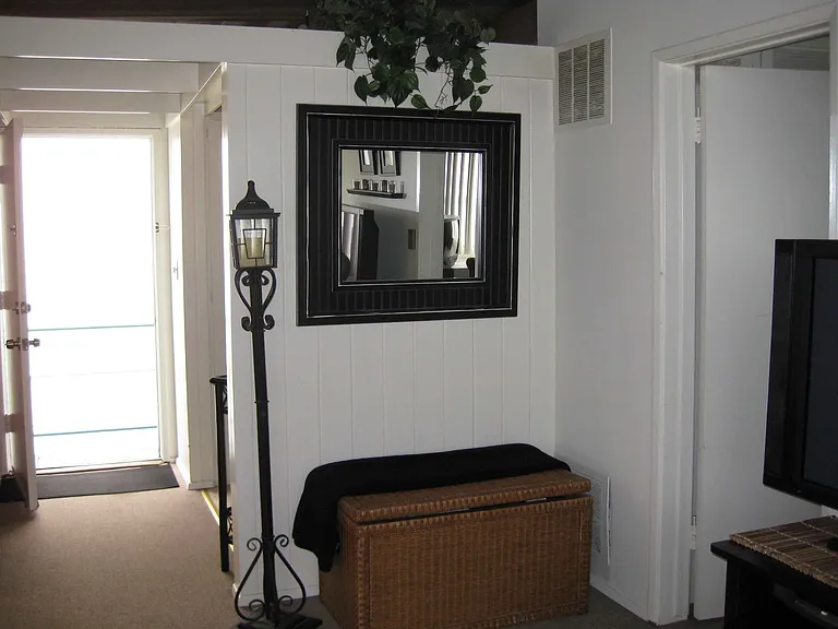 Archival image of the living room showing the front door.