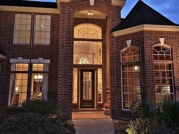 IMPRESSIVE TWO-STORY ENTRY - Stately elegance describe the entrance to the home through a solid wood lead glass front door.