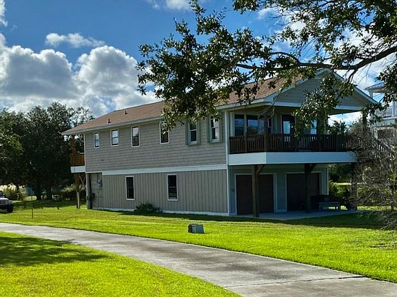 Home is on piling. Automatic garage door to the left with parking inside for one vehicle or two small vehicles. Parking pad also.