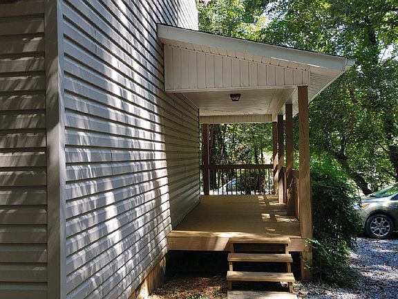 Stairs to porch near parking.