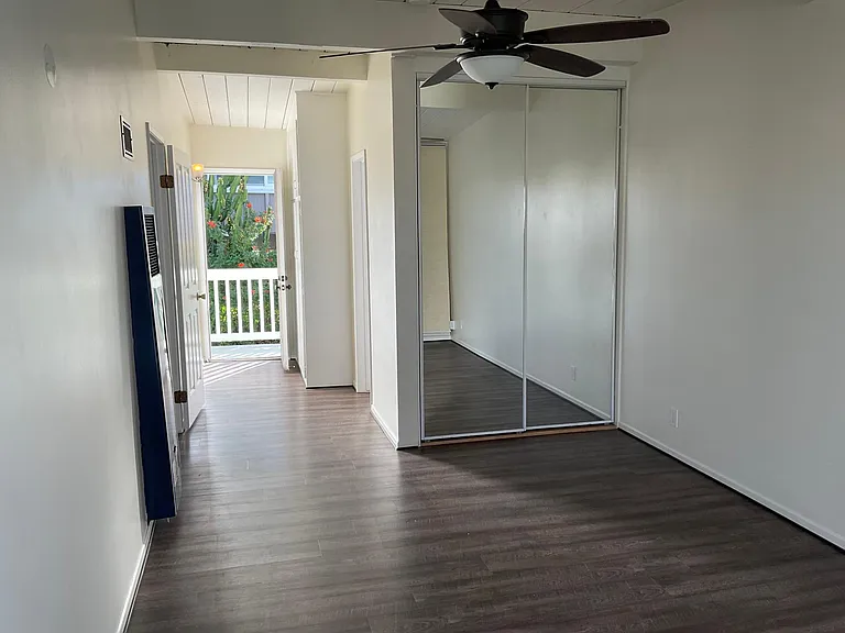 Master bedroom looking in from the balcony. Mirrored closet wardrobes.