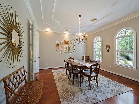The bright dining room is showcased in the front of the house with decorative ceiling and palladium windows.