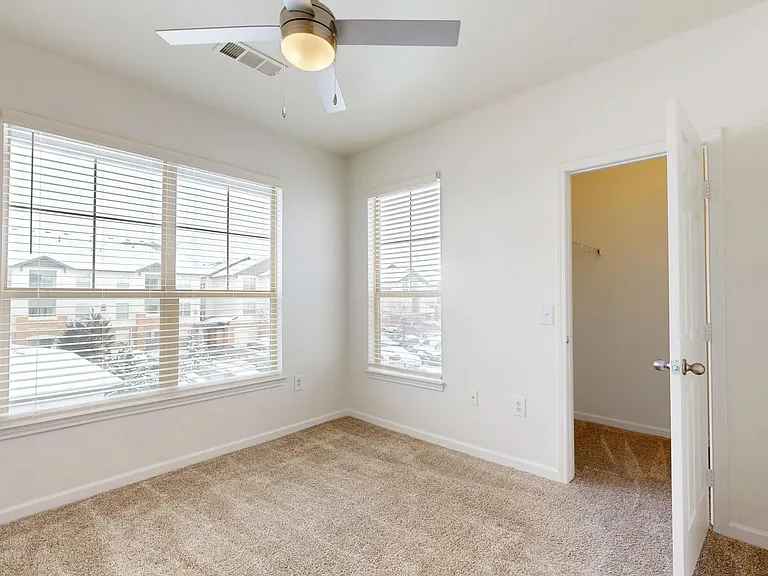 Spacious apartment Bedroom with Large Closet and Carpet Floor.