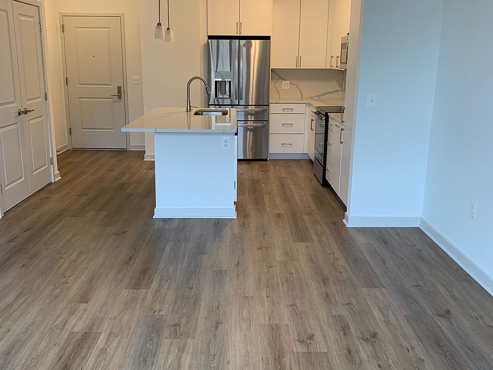 View of dining/living area and kitchen/island from windows side