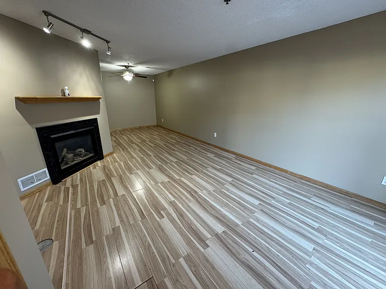 Living full view with gas fireplace and dining