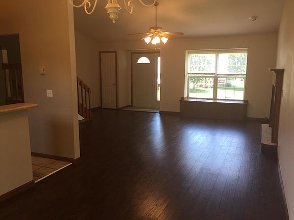 in dining room, kitchen on left, great room straight ahead, fireplace on right, facing front door