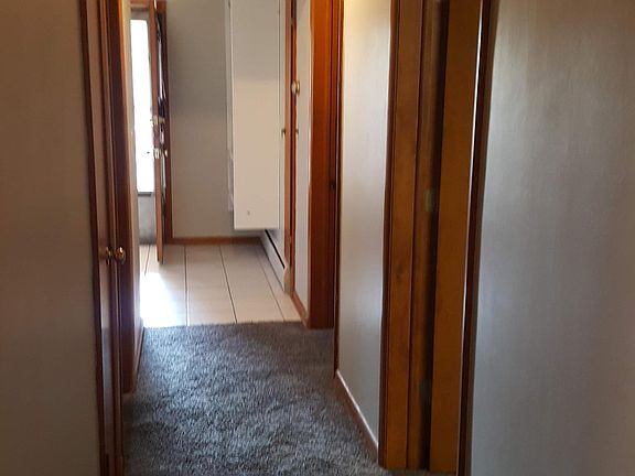 Hallway to 2 bedrooms on the right / laundry room/ full bathroom/ back porch area
