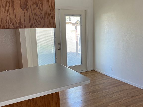 From the Livingroom, looking out to patio area through double patio doors with built in blinds.