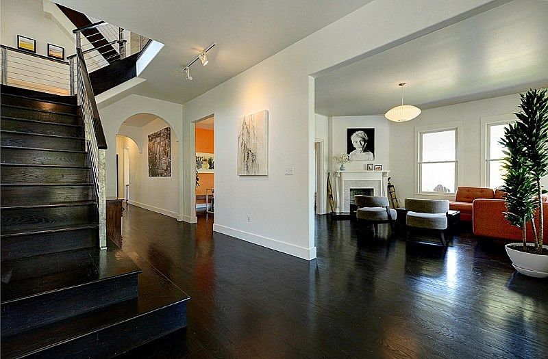 Front entry, main staircase, living room and central hallway that leads to dinning area, den and kitchen. Ebony stained Oak hardwoods throughout most areas. Ten foot ceilings on the first and second levels.