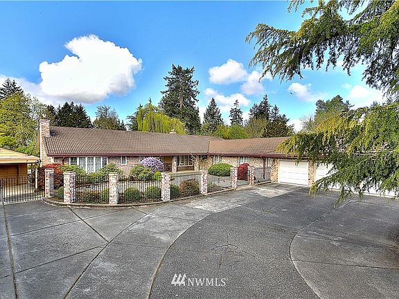 Gated, lots of parking space, three car attached garage and one car detached garage with carport.