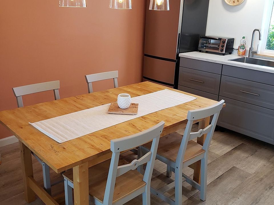 The kitchen with dinning table, 4 new chairs, four chandelier lights for a festive dinner lighting.