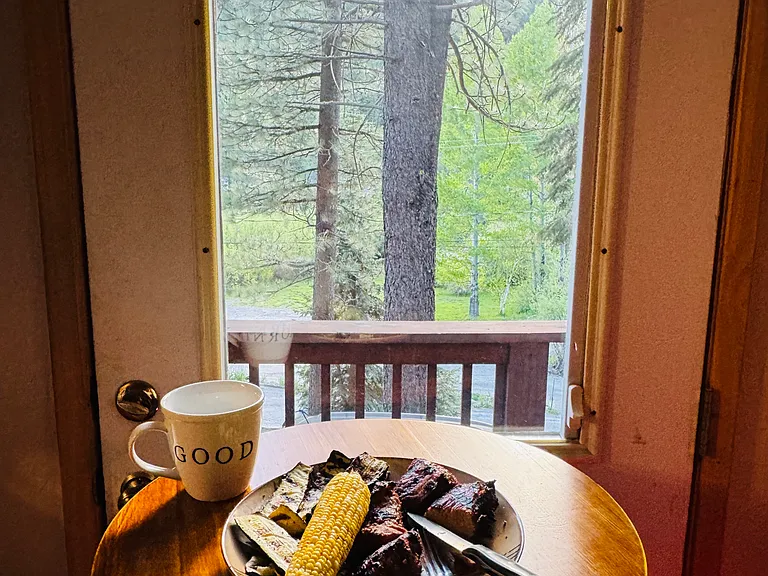 Breakfast nook overlooking the forest and river. Enjoy your morning coffee while watching the birds, or unwind after a BBQ dinner with a peaceful evening in nature.