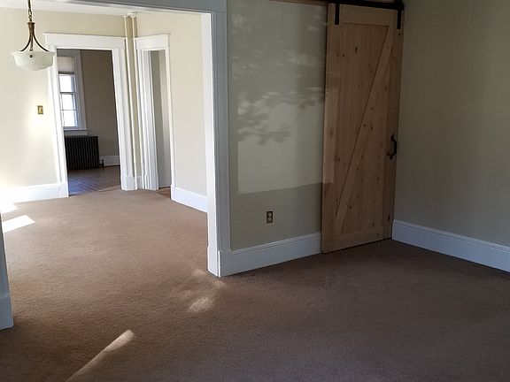Living Room with Barn Door to Full Basement