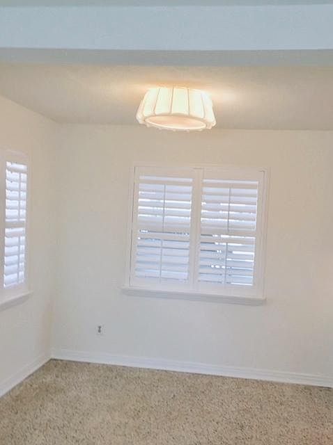 Dining room has dimmable light fixture and 2 sets of windows