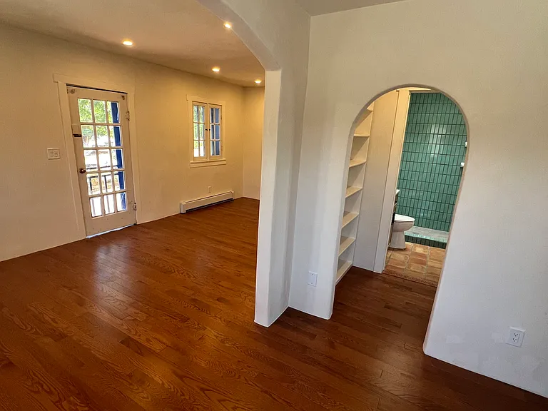 Dining area looking into bathroom and living room.