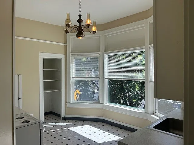 Kitchen with another full set of bay windows and vintage chandelier!