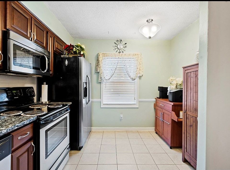 Bar cart has been replaced with a table and two chairs for this eat in kitchen.