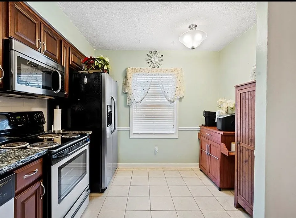 Bar cart has been replaced with a table and two chairs for this eat in kitchen.