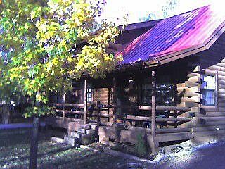 view from front of log cabin in fall
