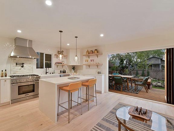 Kitchen opens to backyard deck and garden
