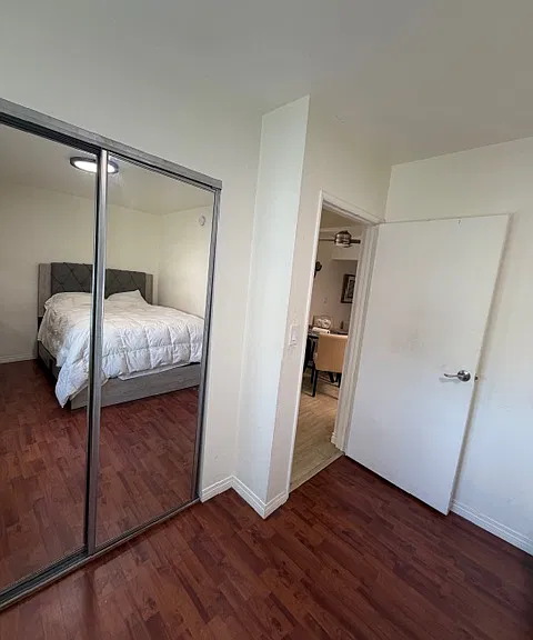 closet of third bedroom and looking into dining room / kitchen