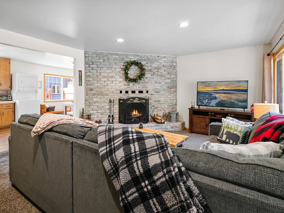 Living room with Smart TV and wood burning fireplace. Large/comfy sectional couch.