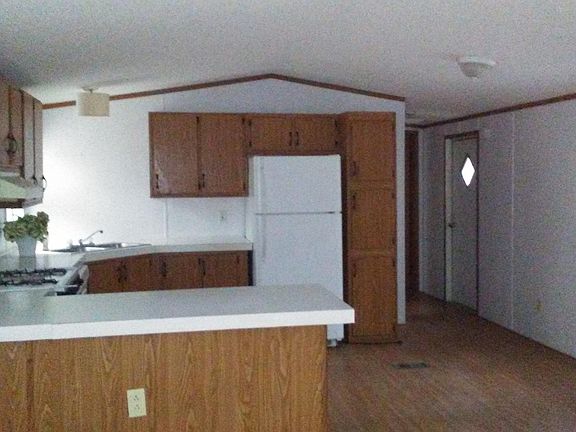 Large open floor plan with kitchen, dining, and living room. Kitchen has peninsula for bar stools!