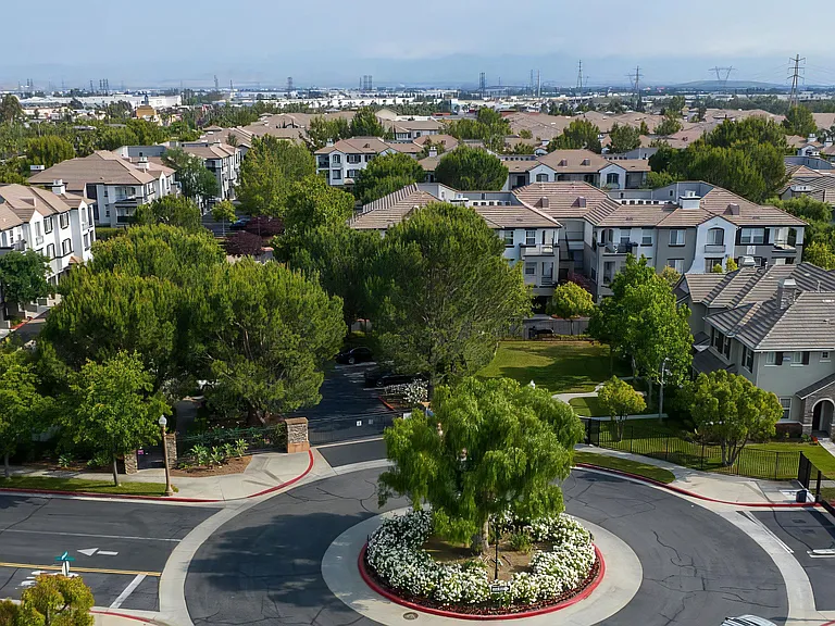 Gated Roundabout Entrance with Landscaping at Villas at the Gardens