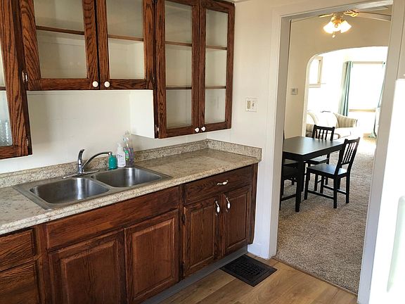 Plenty of cabinet space in a bright, hard-wood floor kitchen.