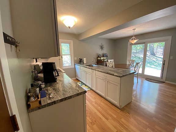eat in kitchen with sliding glass doors looking out over private wooded backyard