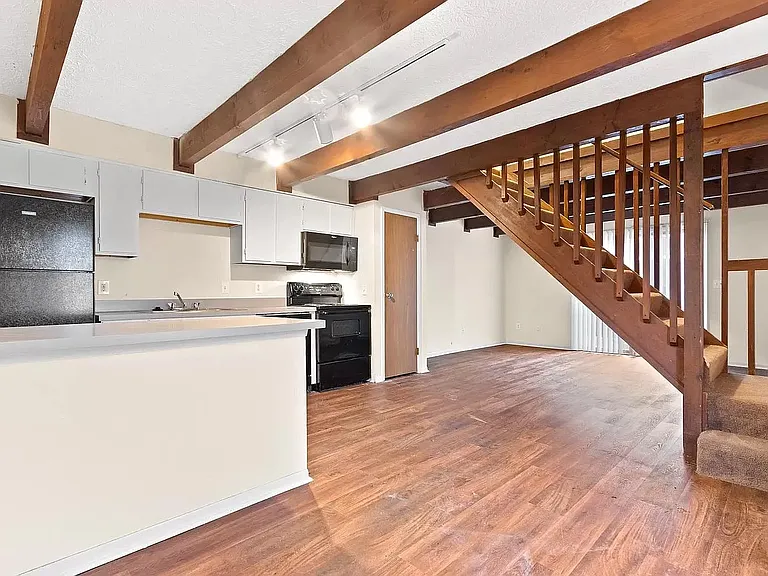 This home features a modern kitchen with updated appliances such as oven, stove, dishwasher and fridge.