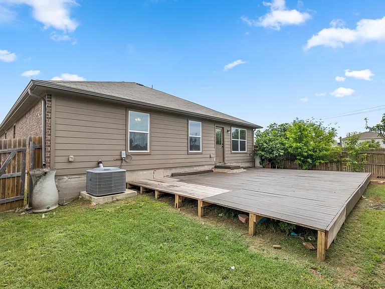 beautiful backyard with a deck to grill and enjoy the sun!