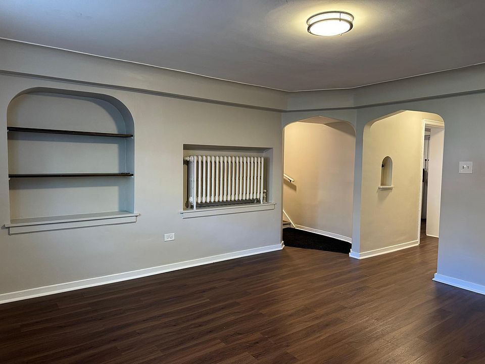 Entryway and living room with built in book case.