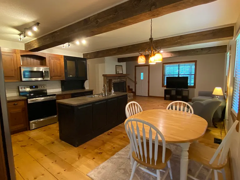 View of downstairs shared space - furnished dining area and living room area.