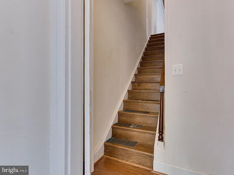 Stairs leading up to the unit. Access through two locked doors.