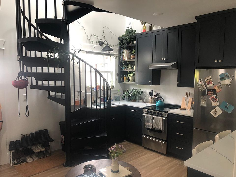 kitchen with spiral staircase to loft