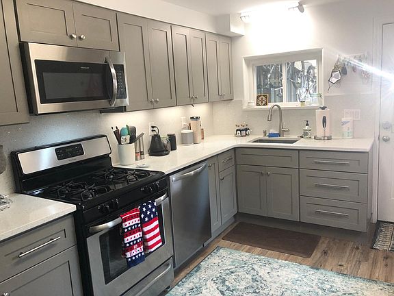 new kitchen w quartz countertops and stainless steel appliances