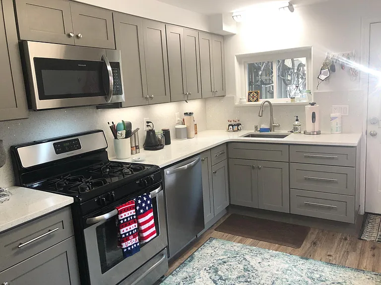 new kitchen w quartz countertops and stainless steel appliances