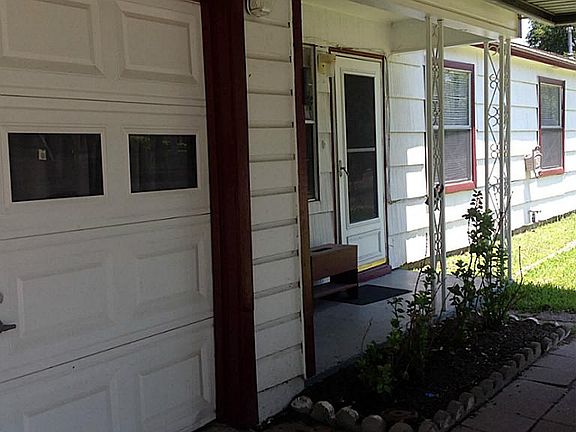 Carport, garage, and Front door of home
