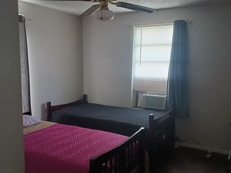 Twin beds and dresser in back bedroom for anyone in need