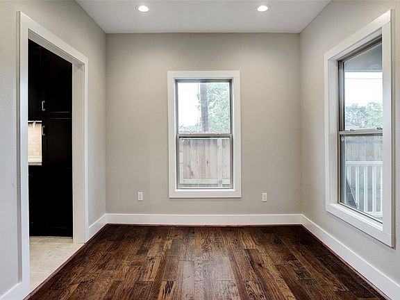 Dining room right off kitchen has hickory wood floors and looks out to the porch.