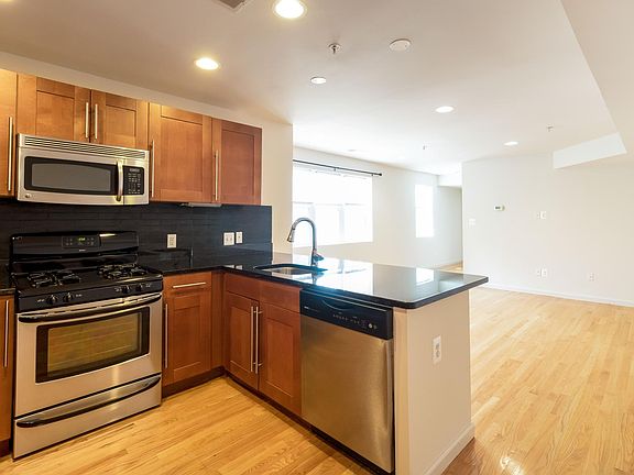 Kitchen with gas stove and dishwasher. Look at that light flooding in!